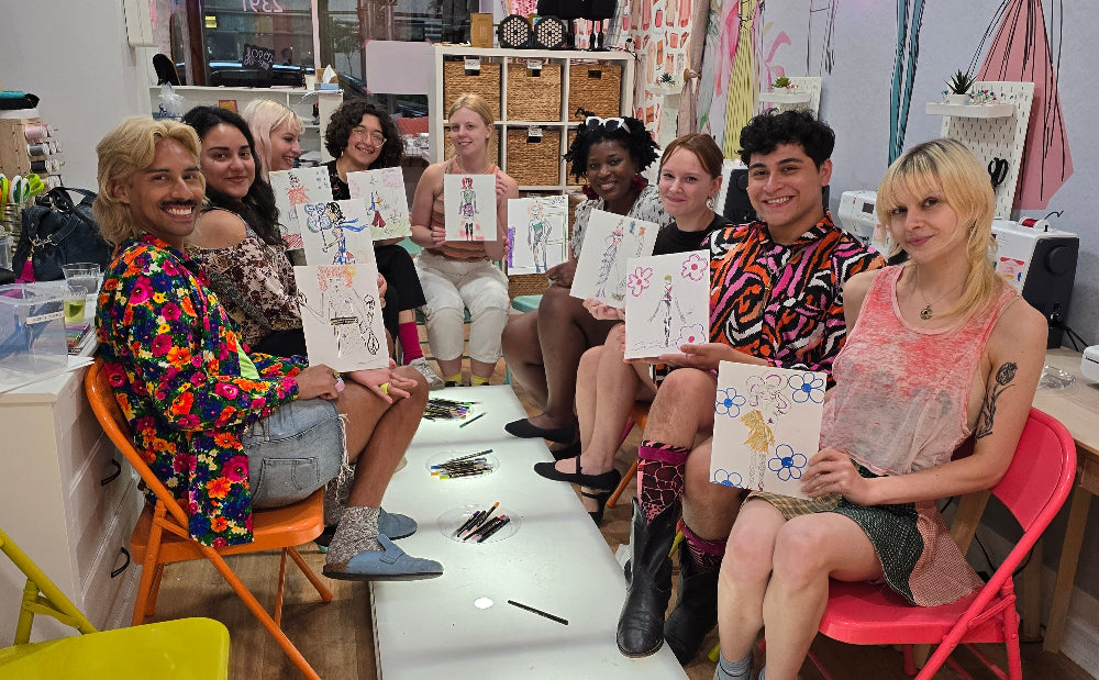 Group of people sitting on colorful chairs in a room with artistic decor.